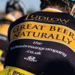 Photograph of a rider's back in a Ludlow Brewery RT jersey